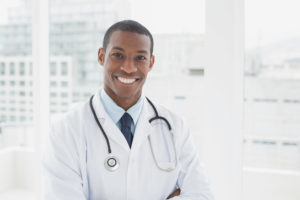 Portrait of a confident smiling male doctor standing in a medical office